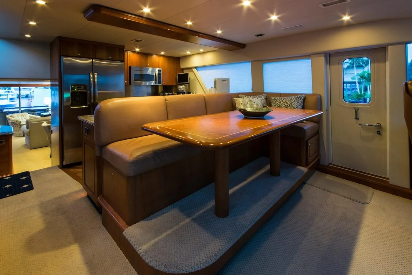 a living room with a table and couches aboard LIFE'S A JOURNEY Yacht for Sale