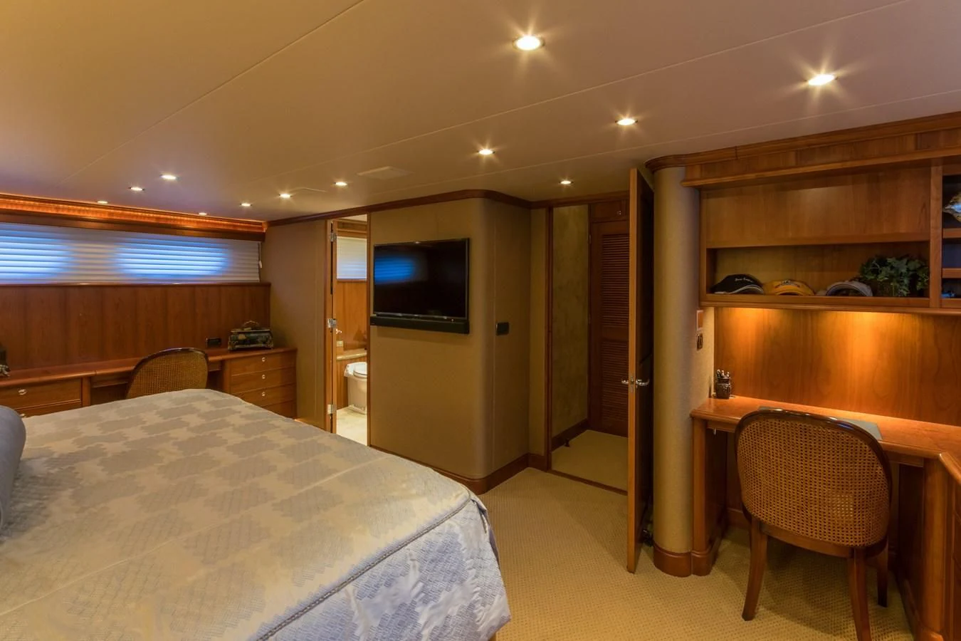 a bedroom with a bed and desk aboard LIFE'S A JOURNEY Yacht for Sale