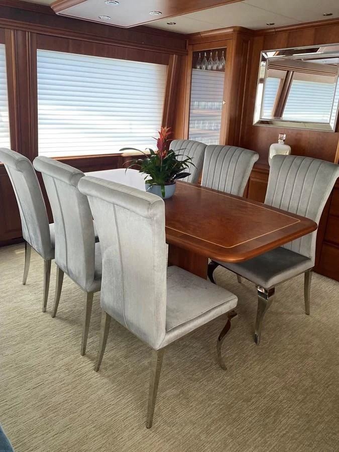 a dining table and chairs in a room aboard LIFE'S A JOURNEY Yacht for Sale