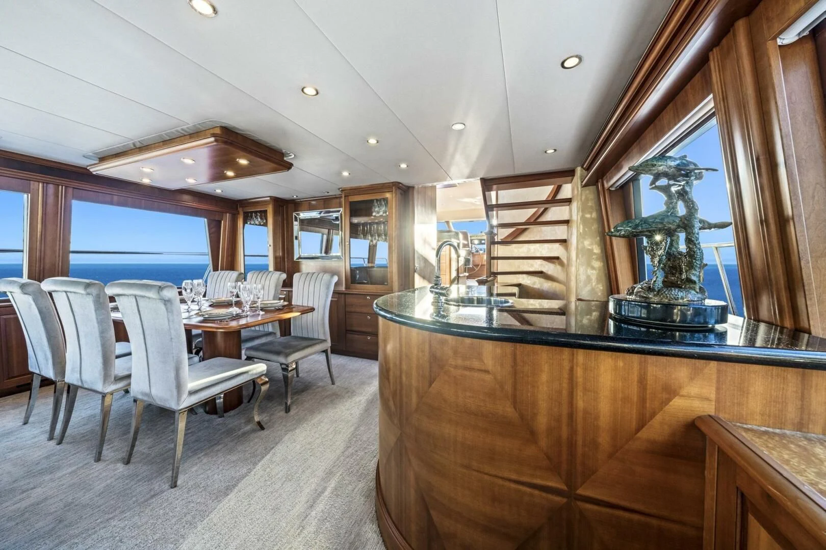 a large dining room with a wood table and chairs aboard LIFE'S A JOURNEY Yacht for Sale