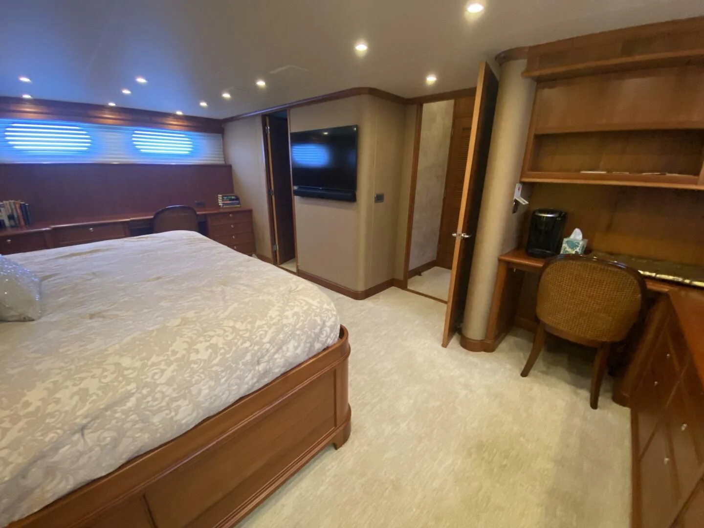 a room with a bed and a desk aboard LIFE'S A JOURNEY Yacht for Sale