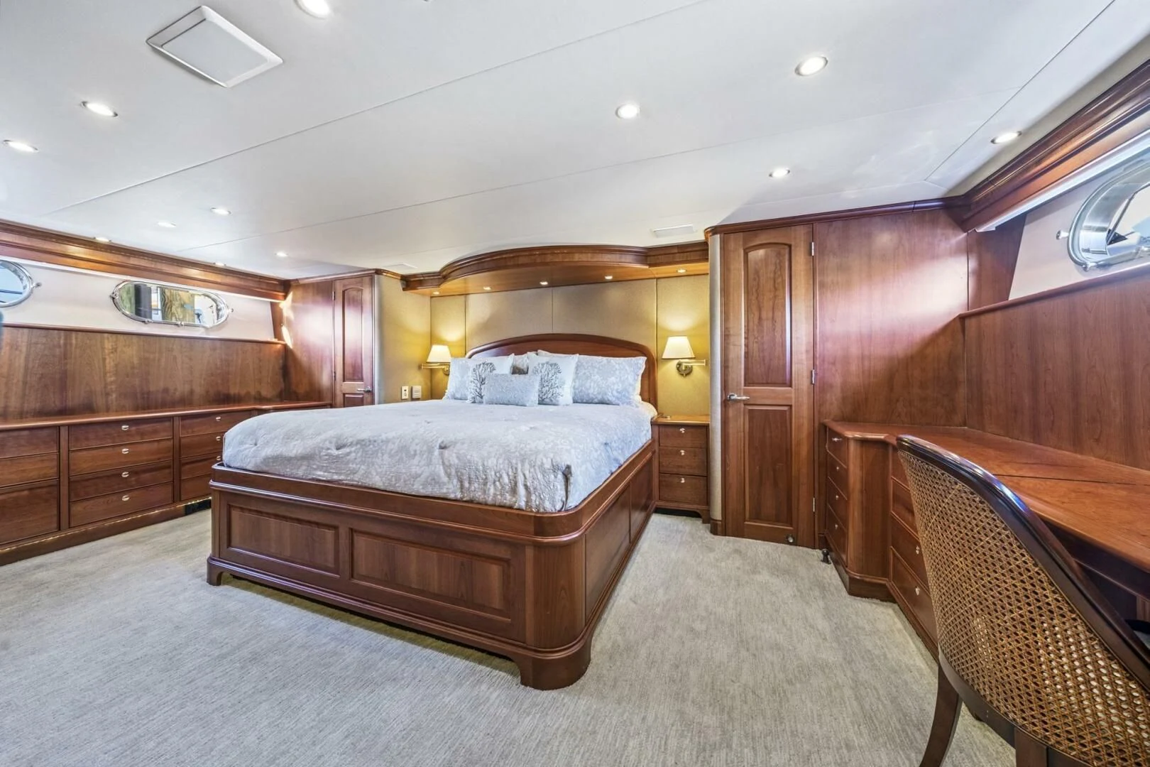 a bedroom with a bed and a chair aboard LIFE'S A JOURNEY Yacht for Sale