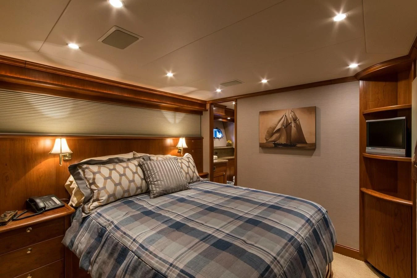 a bedroom with a bed and a television aboard LIFE'S A JOURNEY Yacht for Sale
