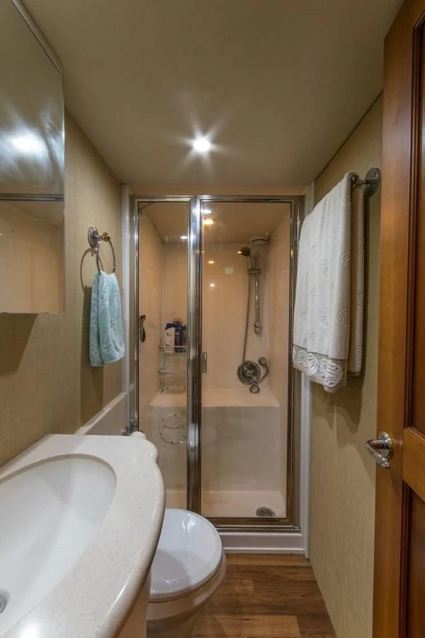 a bathroom with a glass shower aboard LIFE'S A JOURNEY Yacht for Sale