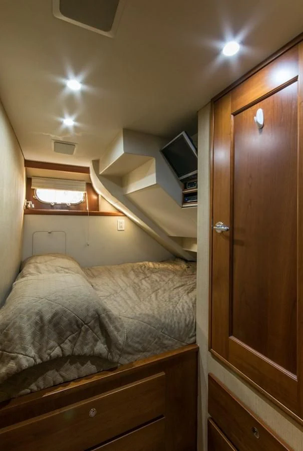 a bedroom with a bed and a closet aboard LIFE'S A JOURNEY Yacht for Sale