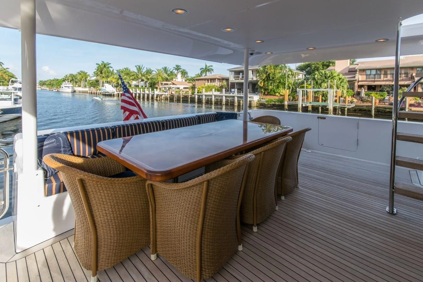 a deck with chairs and a flag on it aboard LIFE'S A JOURNEY Yacht for Sale