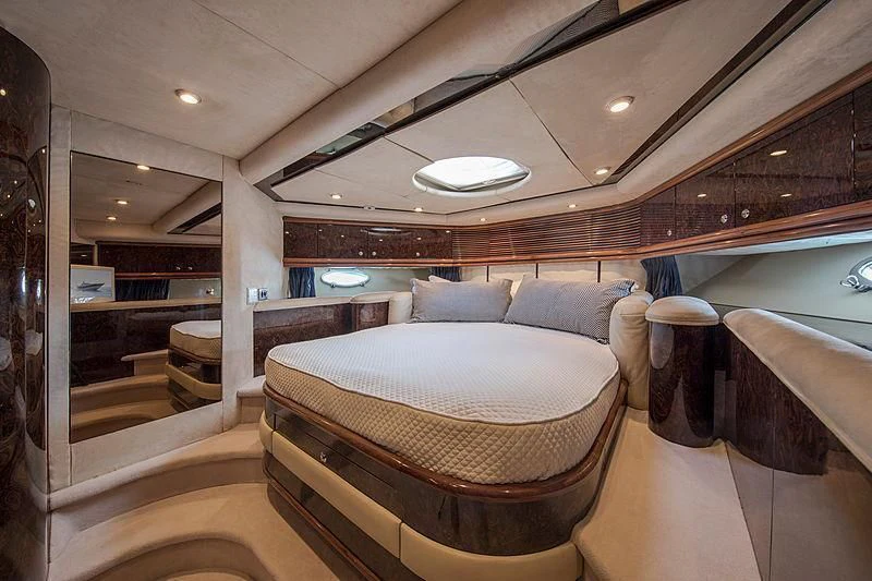 a room with a bed and a chair aboard OSCAR Yacht for Sale