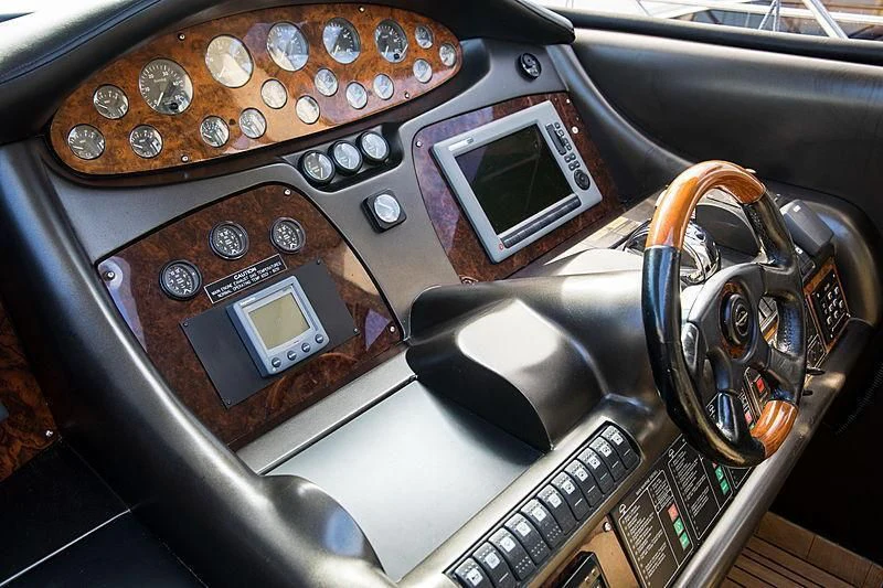 a car with a screen and other electronic devices in it aboard OSCAR Yacht for Sale