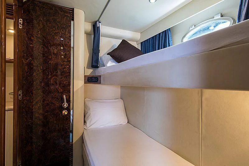 a room with a bed and a closet aboard OSCAR Yacht for Sale