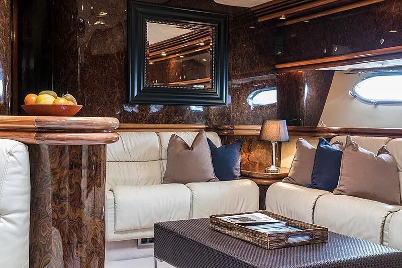 a living room with a couch and a table aboard OSCAR Yacht for Sale