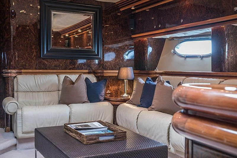 a living room with a couch and a table aboard OSCAR Yacht for Sale