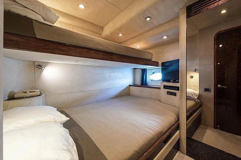 a room with a bed and a television aboard OSCAR Yacht for Sale