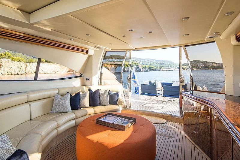 a boat with a couch and a table on it aboard OSCAR Yacht for Sale