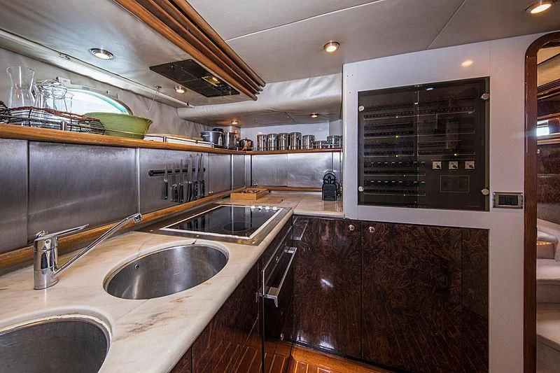 a kitchen with a sink and cabinets aboard OSCAR Yacht for Sale
