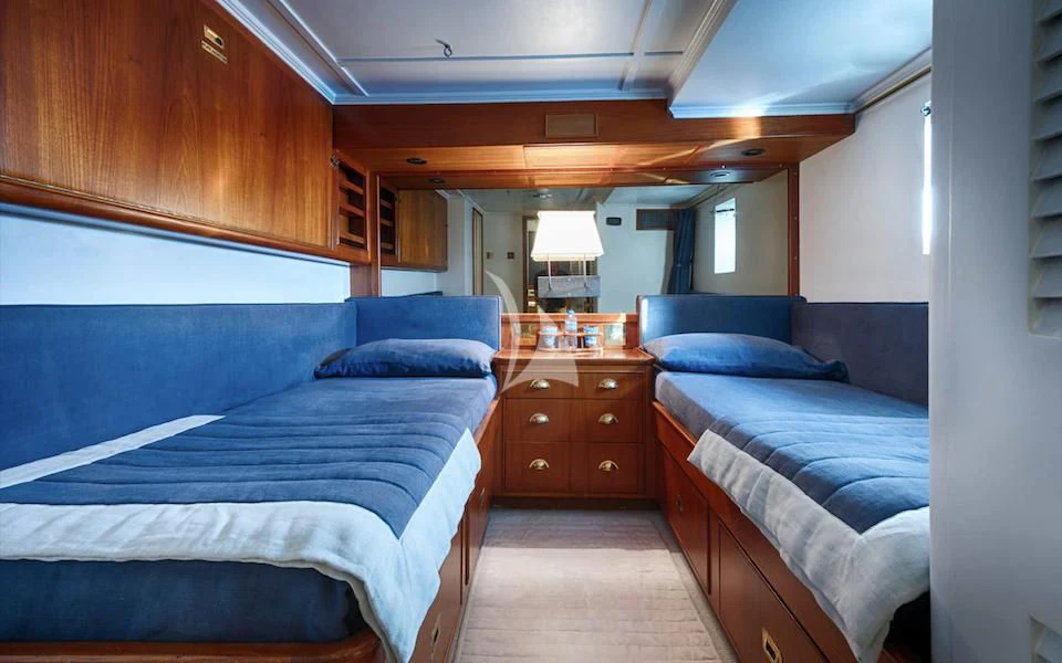 a room with two beds aboard JURA II Yacht for Sale