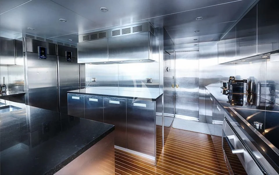 a large kitchen with stainless steel appliances aboard JURA II Yacht for Sale