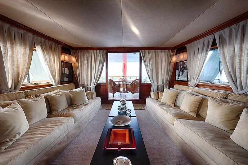 a living room with a large sofa and a coffee table aboard JURA II Yacht for Sale