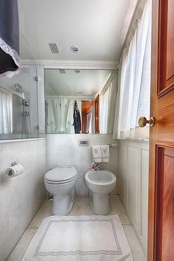 a bathroom with a toilet and a mirror aboard JURA II Yacht for Sale