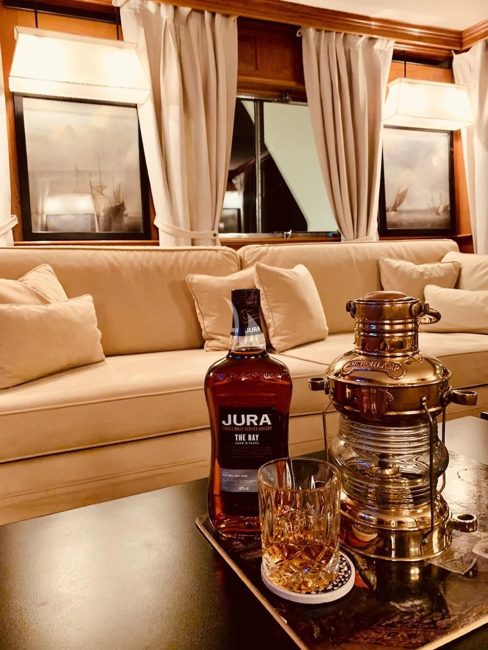 a bottle of liquor on a table aboard JURA II Yacht for Sale