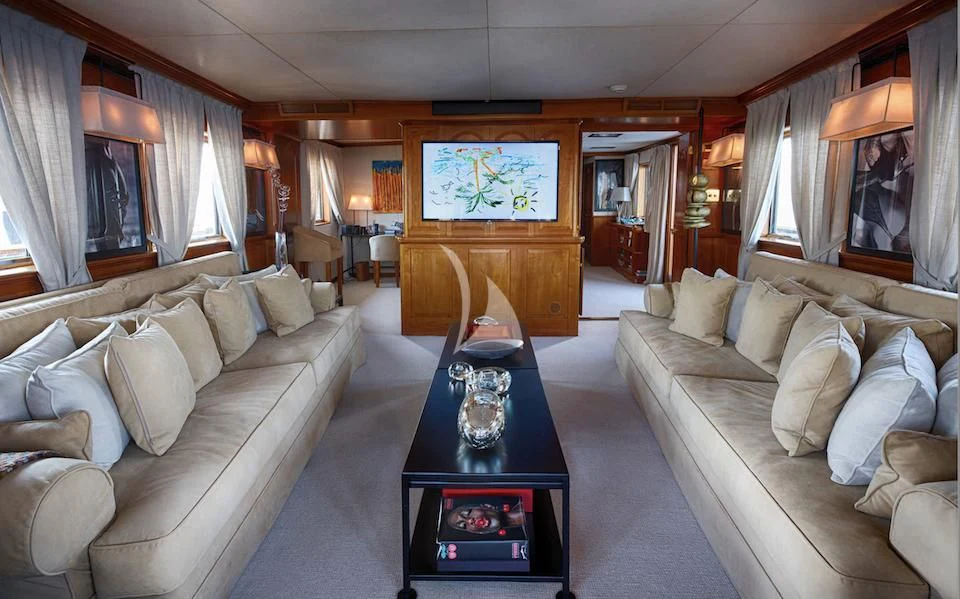 a living room with a couch and a coffee table aboard JURA II Yacht for Sale