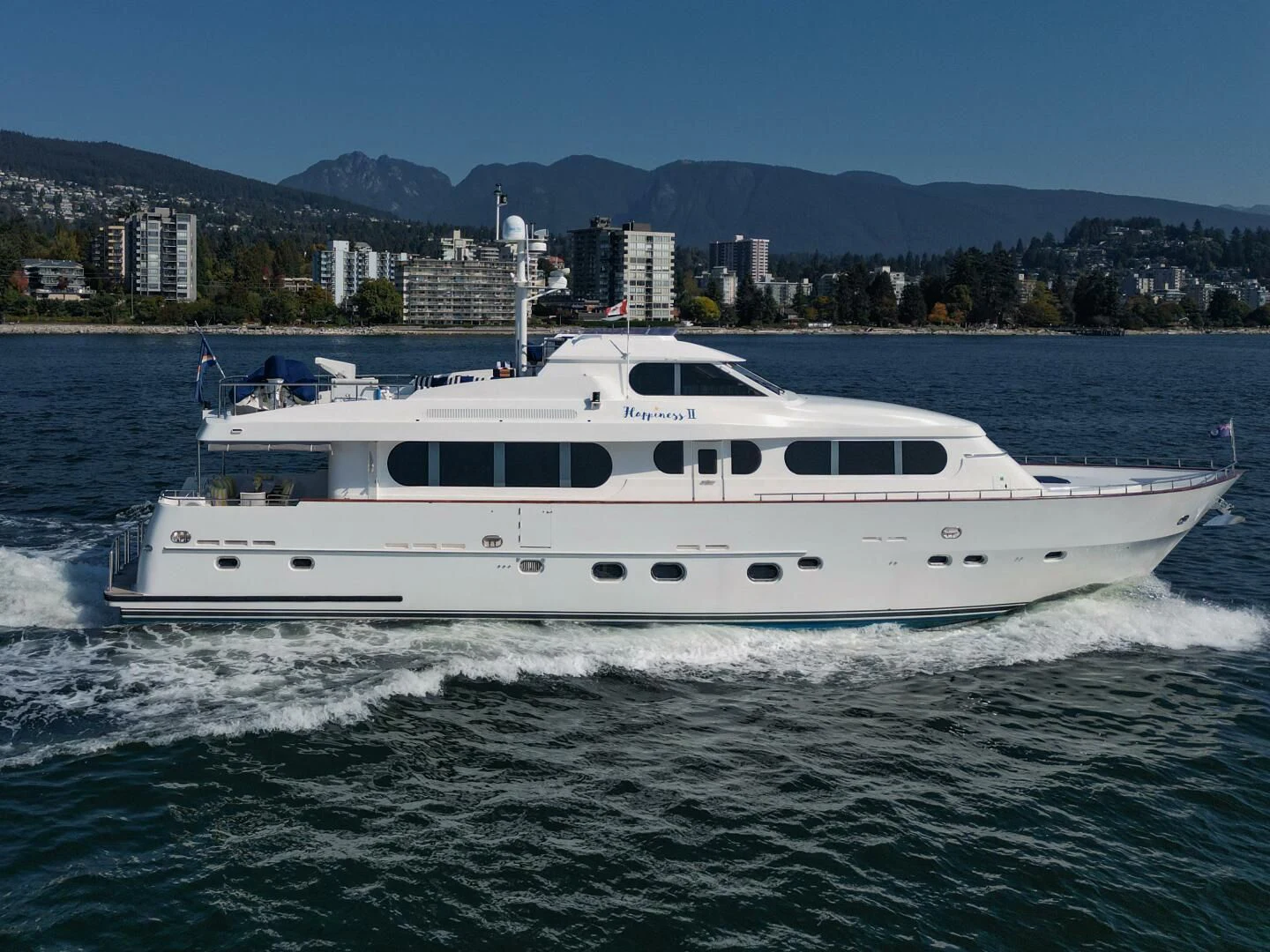 a white yacht on the water aboard HAPPINESS II Yacht for Sale