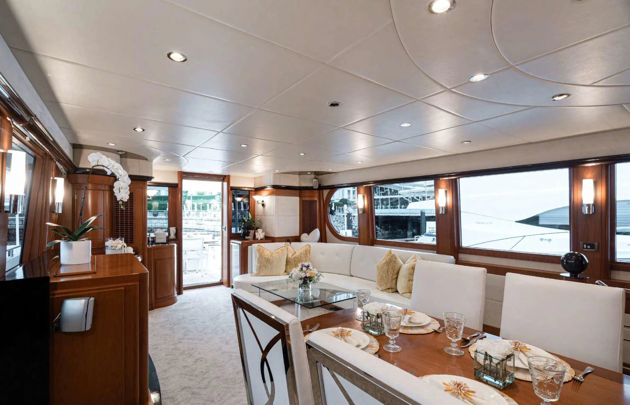 a large dining room with a large white table and chairs aboard HAPPINESS II Yacht for Sale