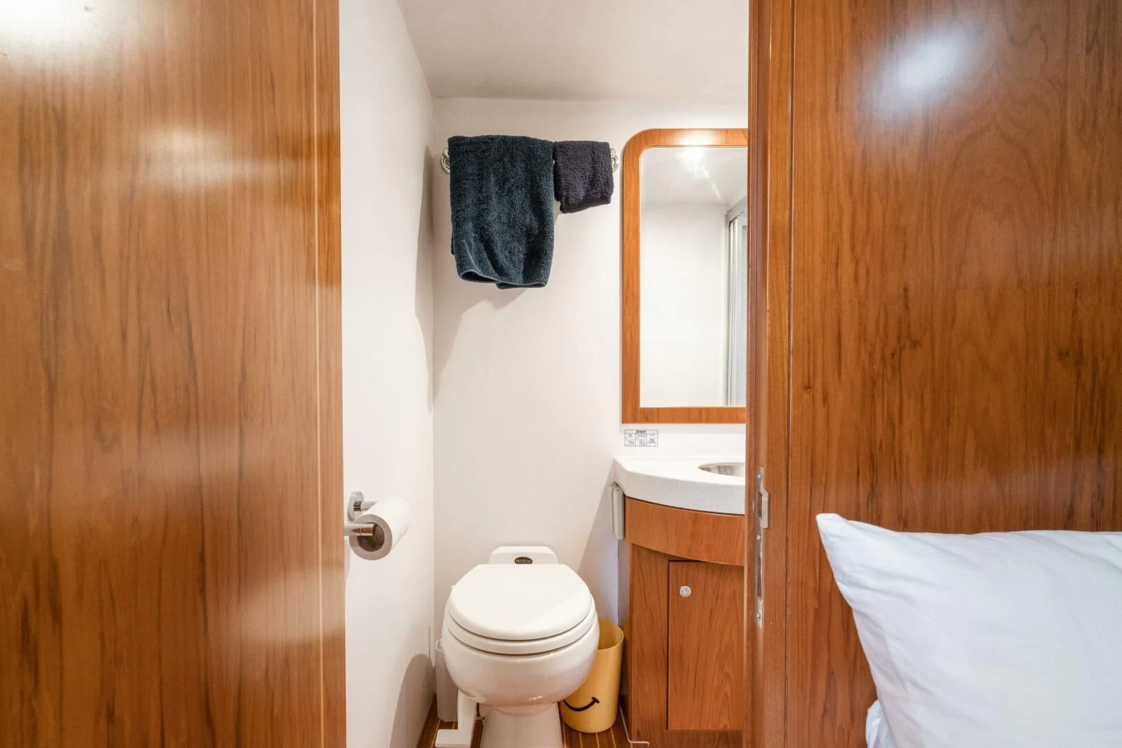 a bathroom with a toilet and a sink aboard HAPPINESS II Yacht for Sale