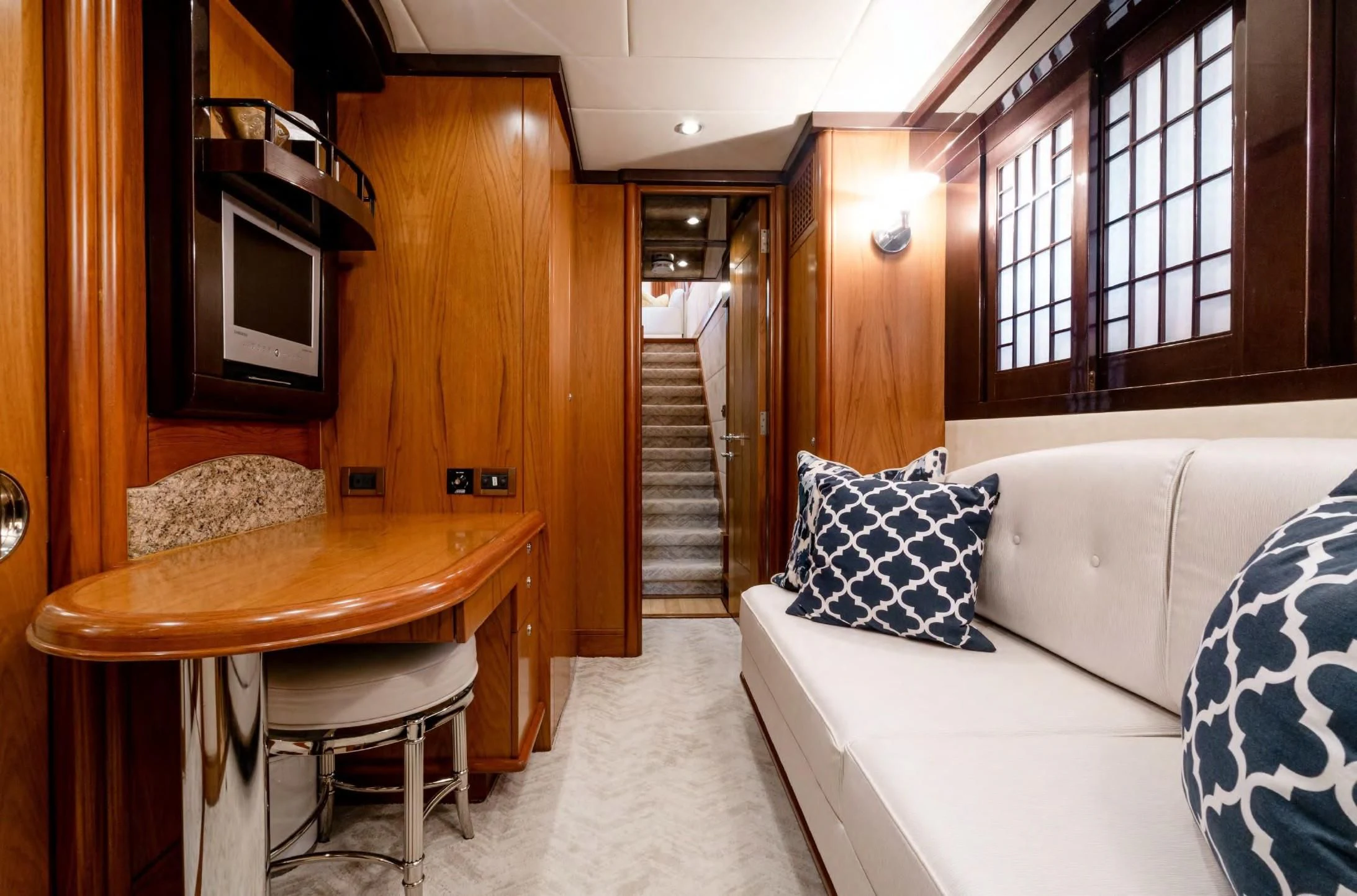 a room with a table and couch aboard HAPPINESS II Yacht for Sale