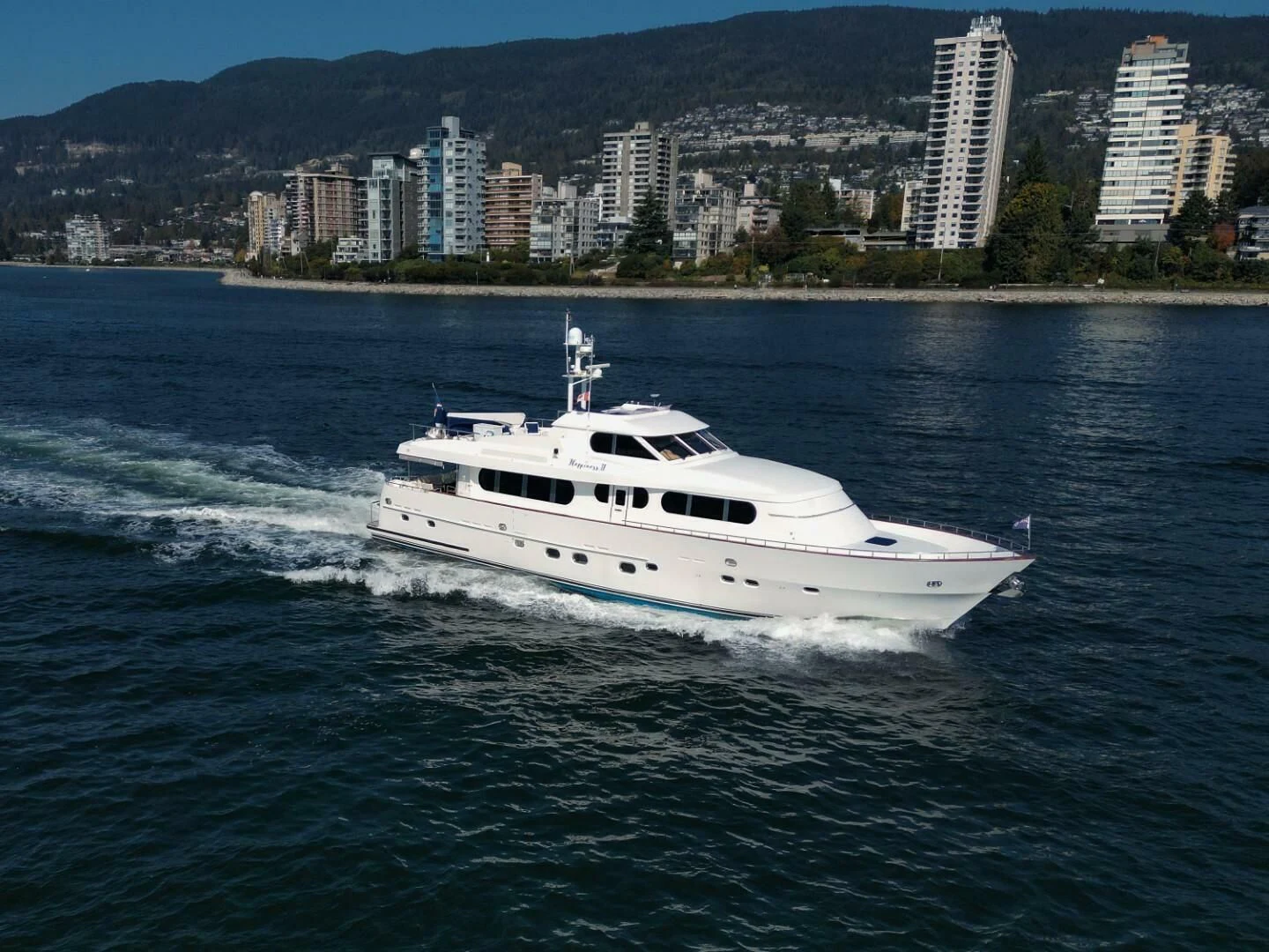a white yacht on the water aboard HAPPINESS II Yacht for Sale