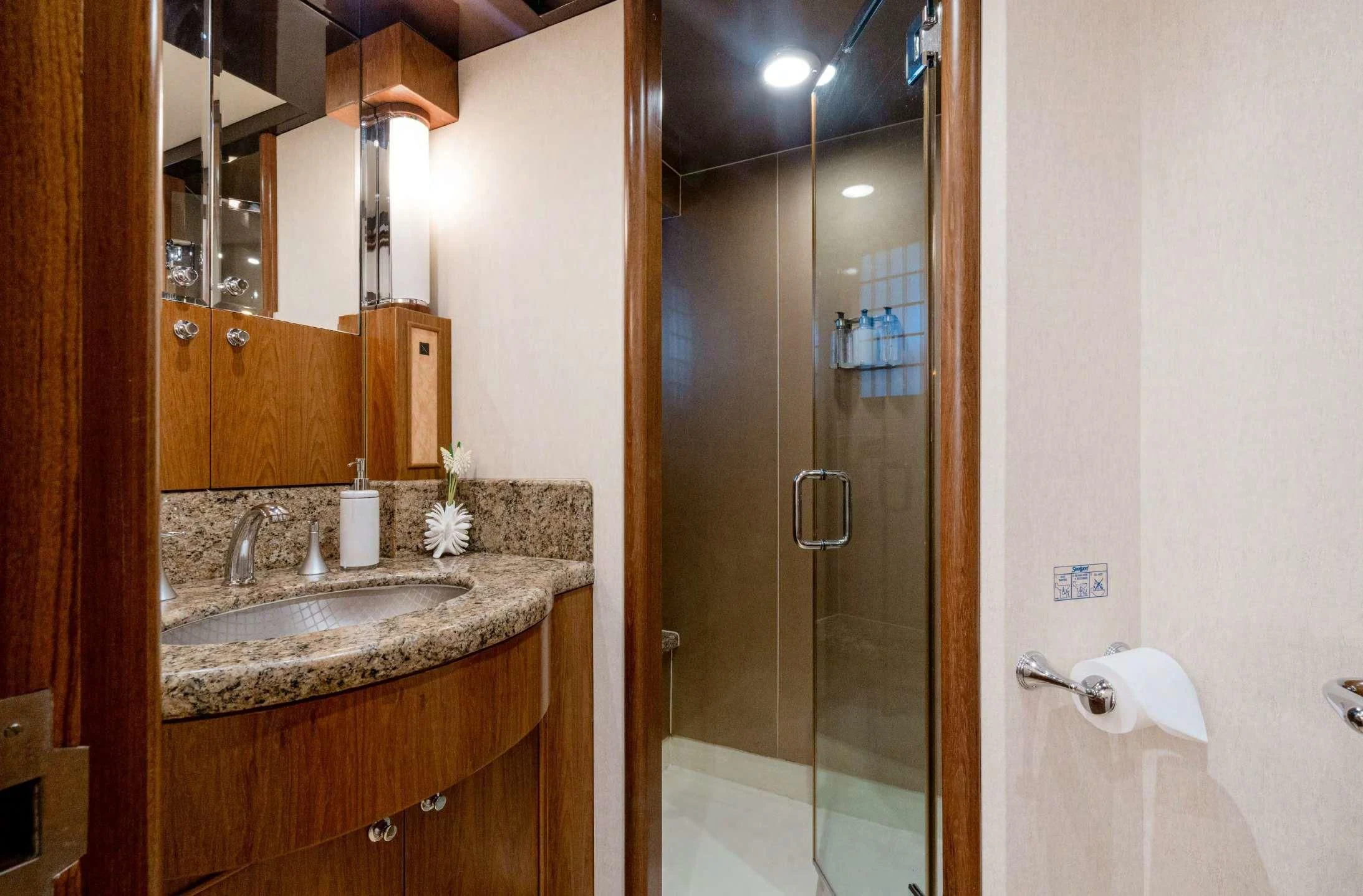 a bathroom with a glass shower aboard HAPPINESS II Yacht for Sale