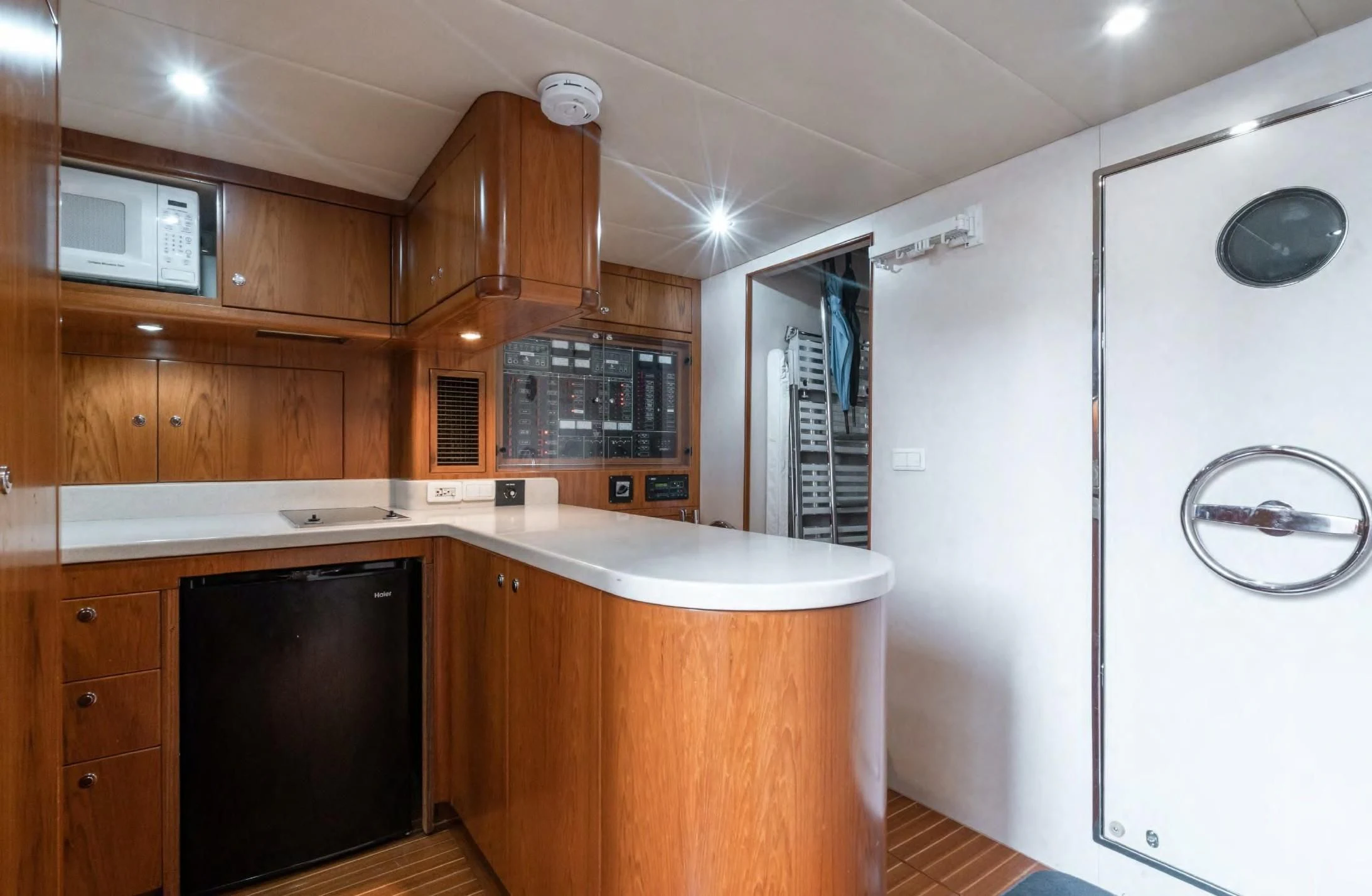 a kitchen with wooden cabinets aboard HAPPINESS II Yacht for Sale
