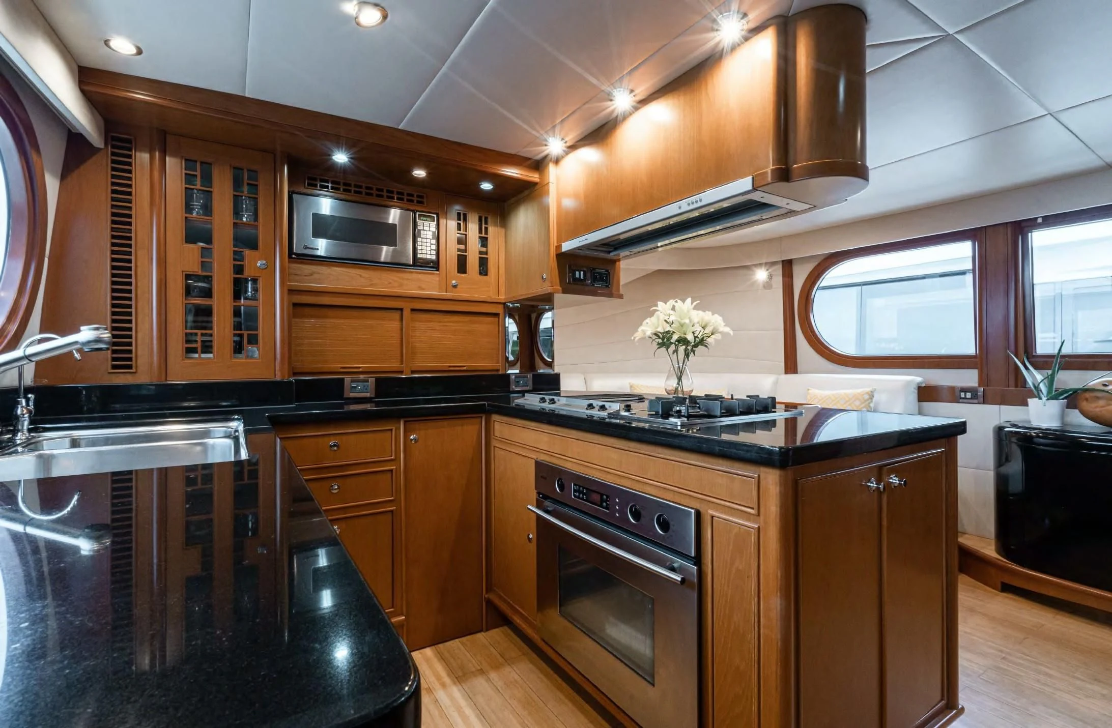 a kitchen with wooden cabinets aboard HAPPINESS II Yacht for Sale