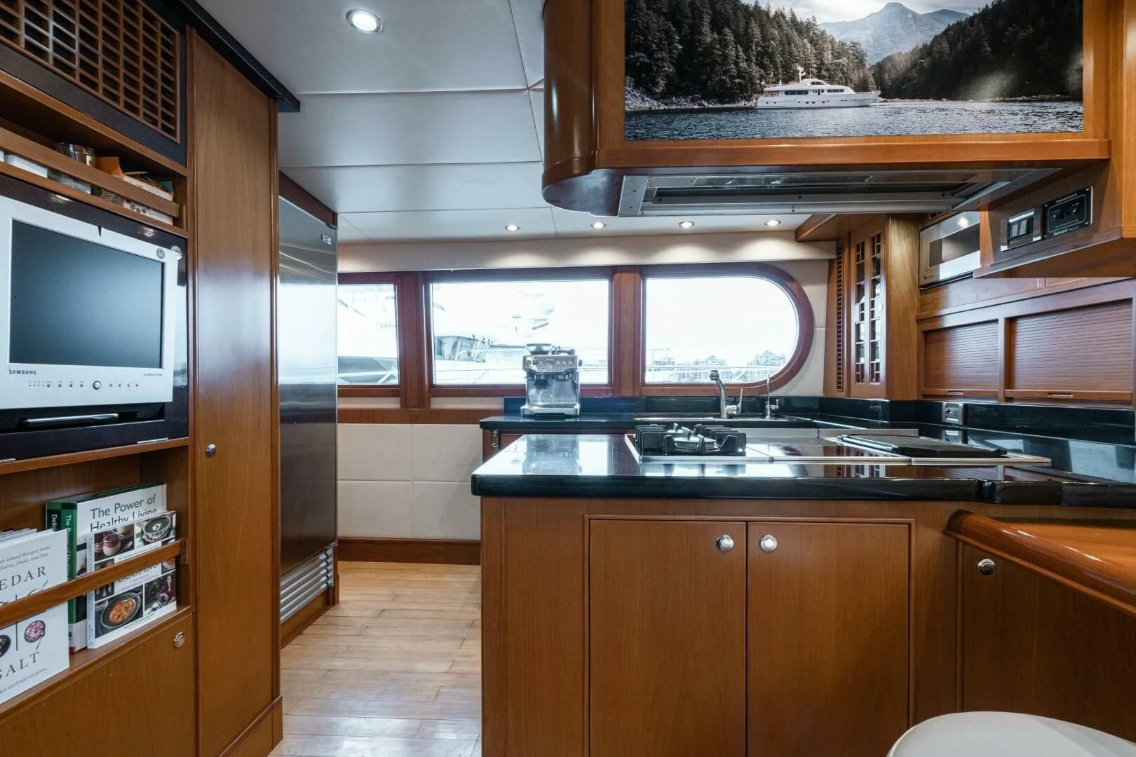 a kitchen with wooden cabinets aboard HAPPINESS II Yacht for Sale