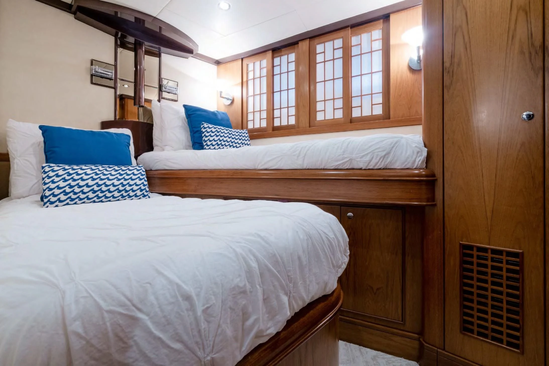 a room with a bed and a wood cabinet aboard HAPPINESS II Yacht for Sale