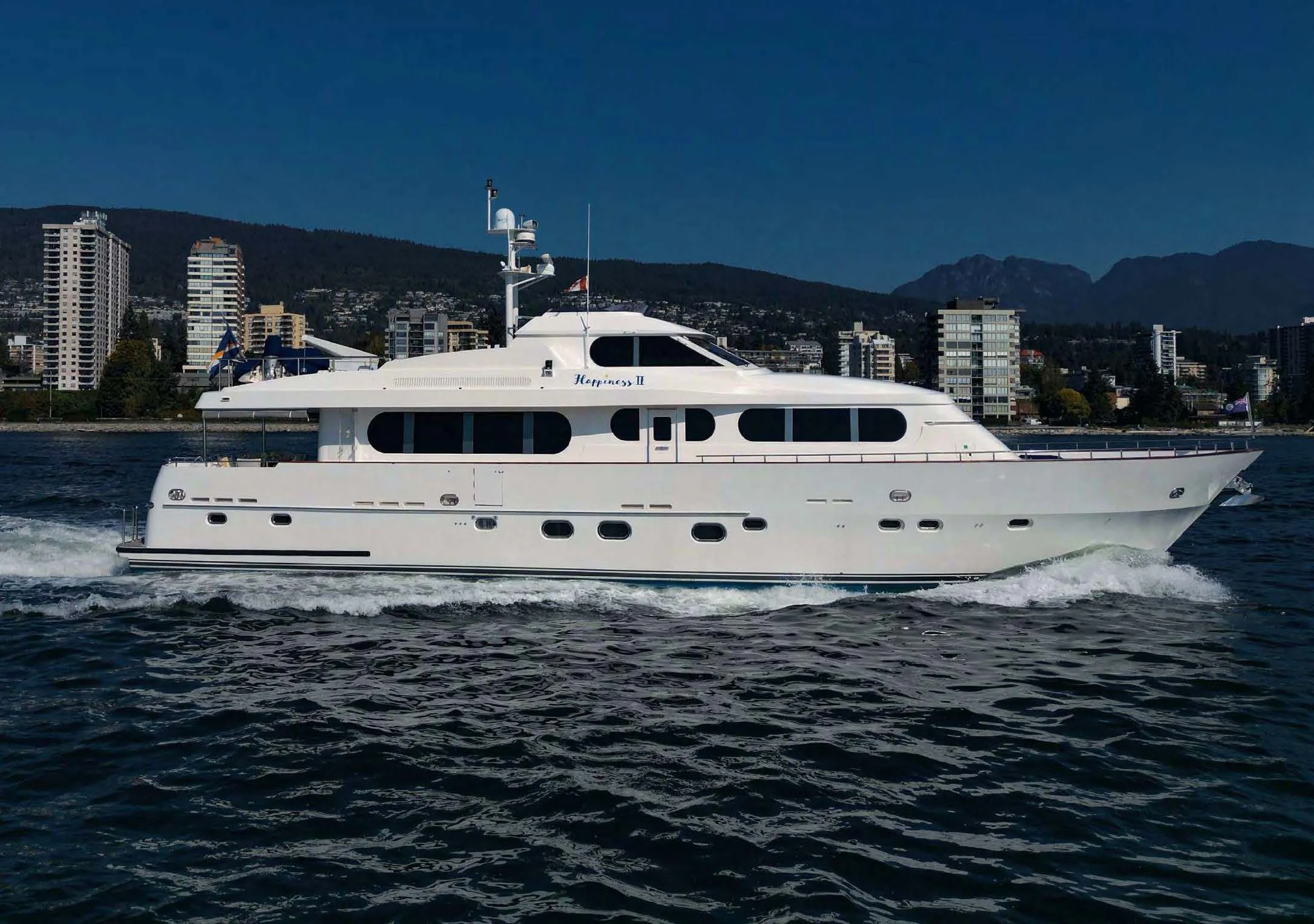 a white boat on water aboard HAPPINESS II Yacht for Sale