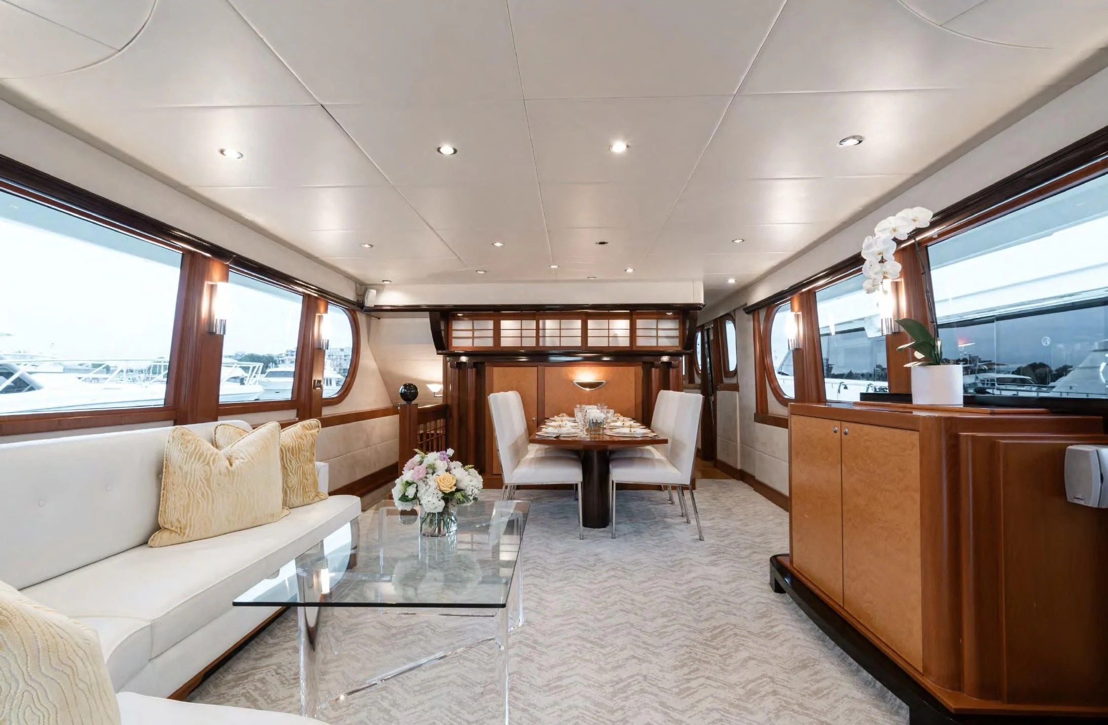 a living room with a table and chairs aboard HAPPINESS II Yacht for Sale
