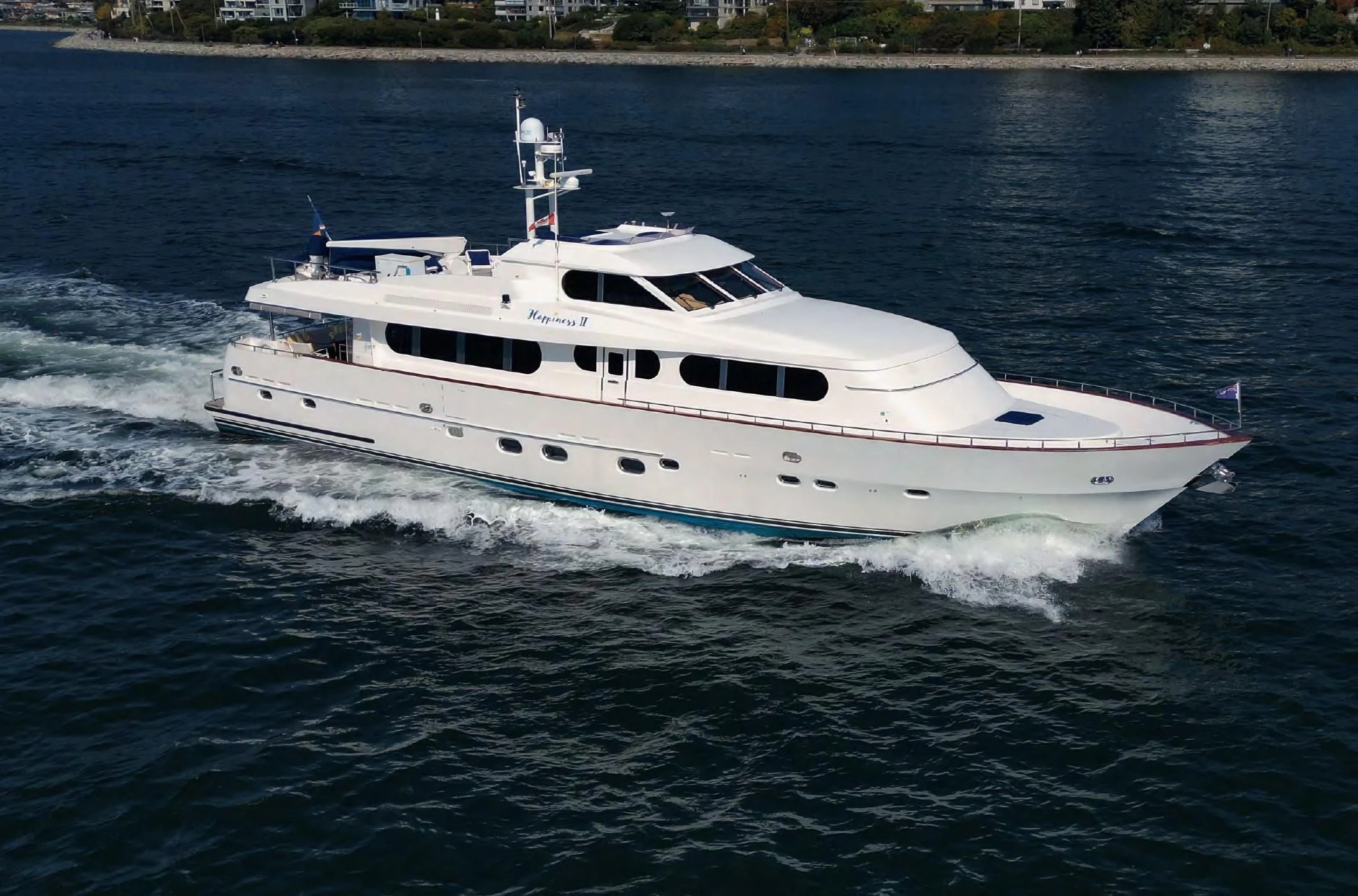 a white yacht on the water aboard HAPPINESS II Yacht for Sale