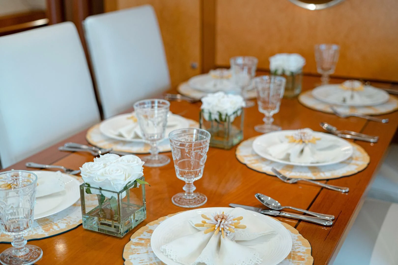 a table with plates and silverware aboard HAPPINESS II Yacht for Sale