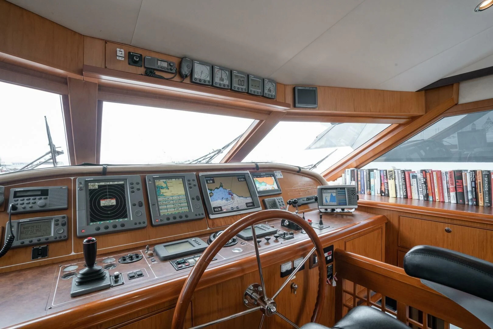 a wooden desk with electronic devices aboard HAPPINESS II Yacht for Sale