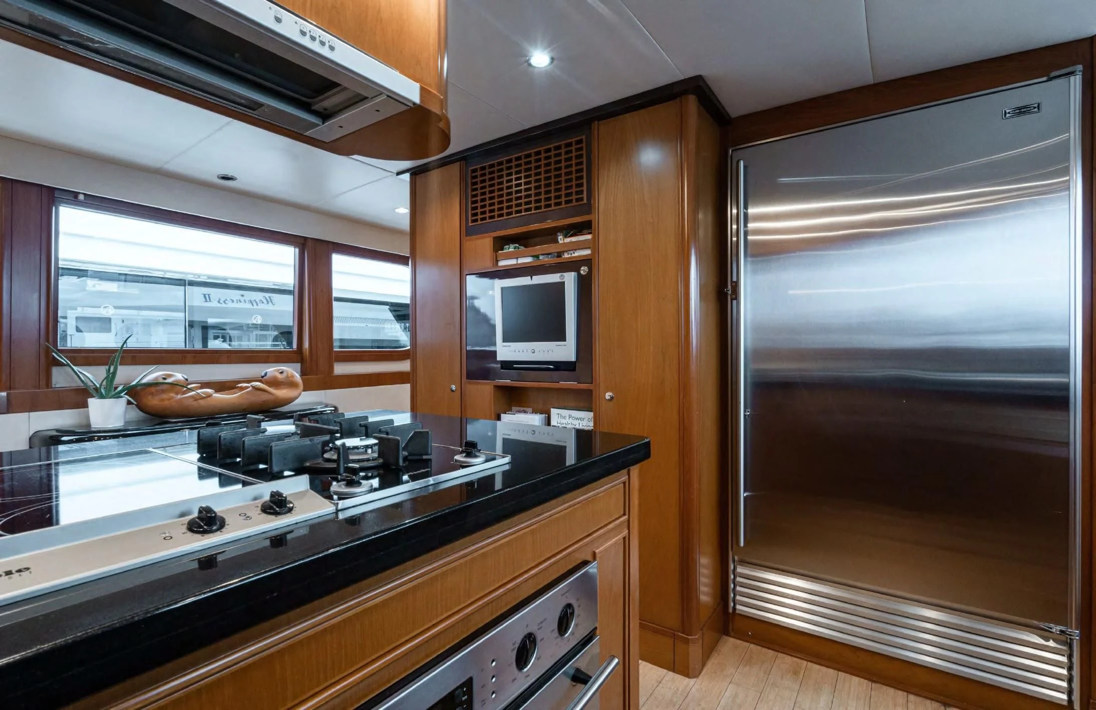 a kitchen with wooden cabinets aboard HAPPINESS II Yacht for Sale