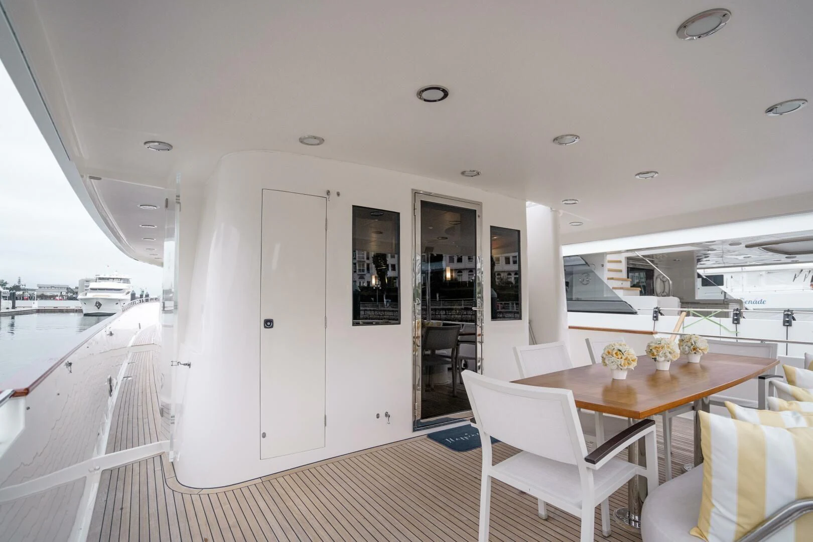 a large white room with a table and chairs aboard HAPPINESS II Yacht for Sale