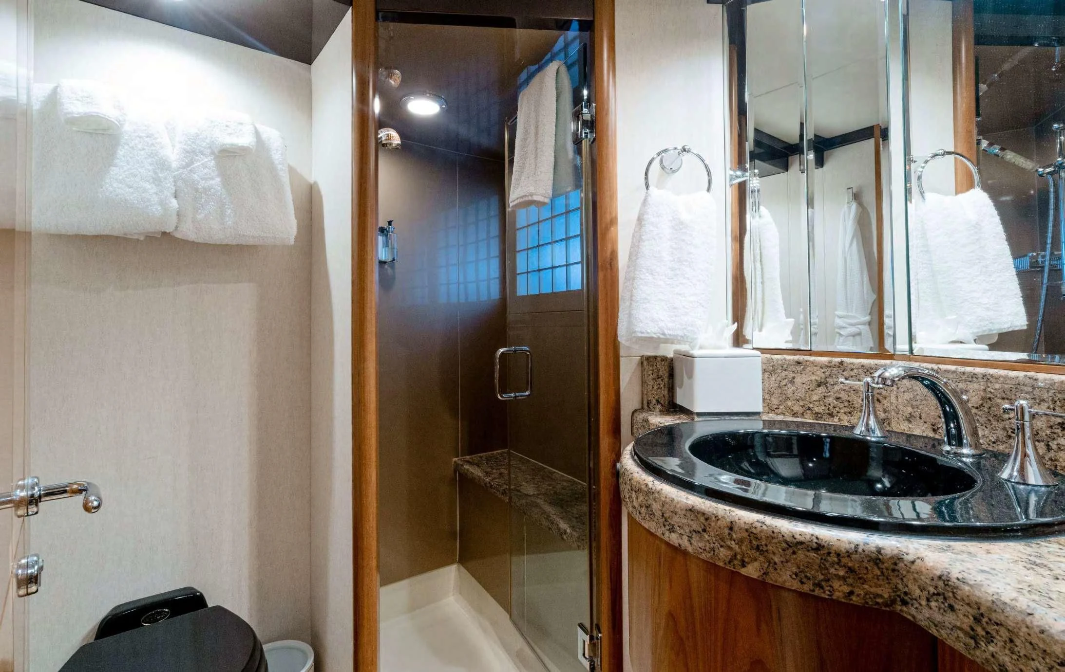 a bathroom with a sink and a shower aboard HAPPINESS II Yacht for Sale