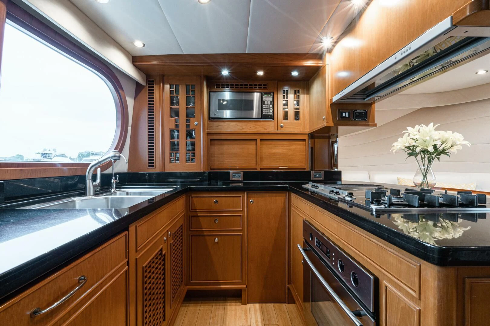 a kitchen with wooden cabinets aboard HAPPINESS II Yacht for Sale
