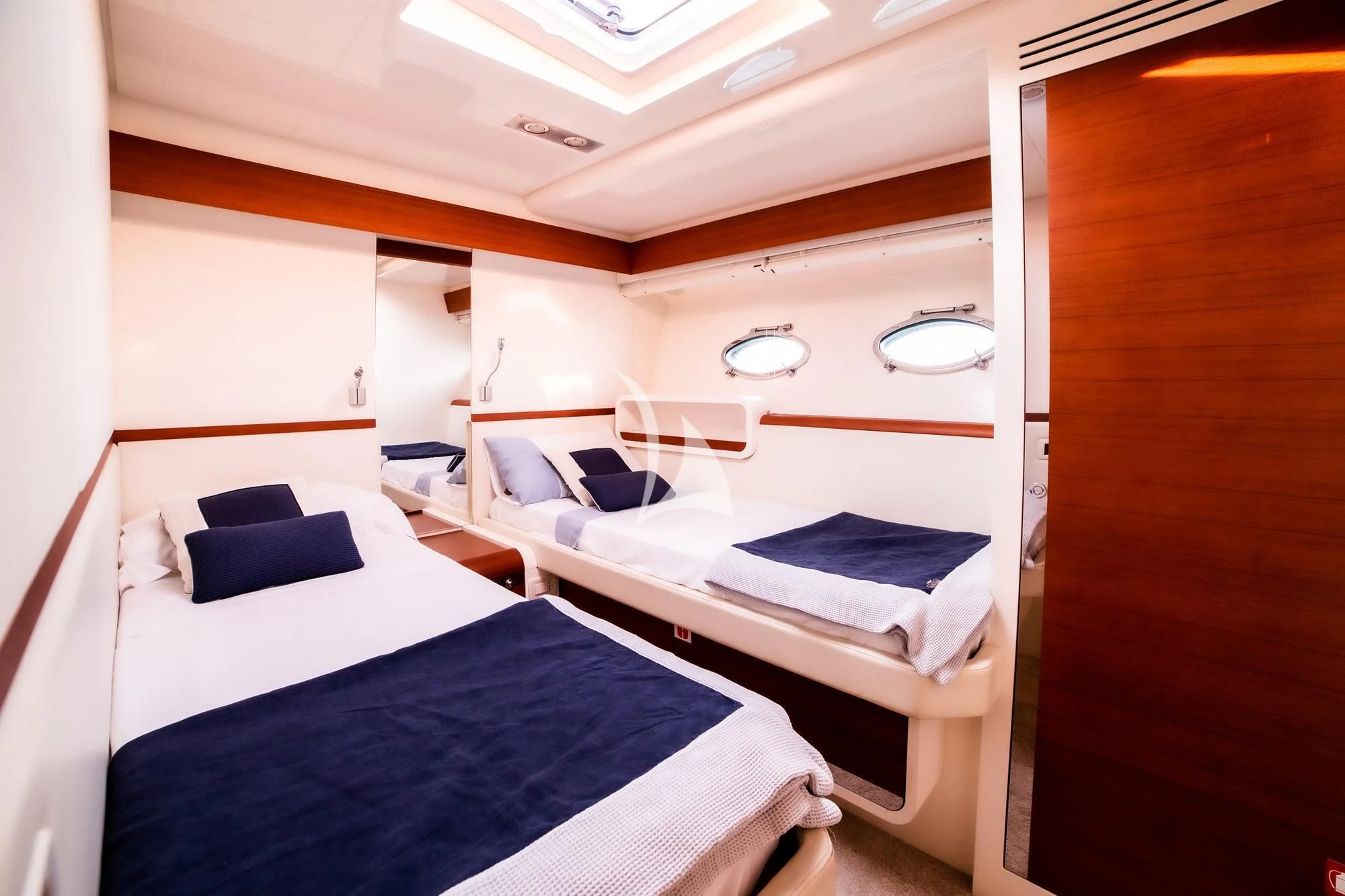 a room with beds and a wood door aboard BLUE MAMBA Yacht for Sale