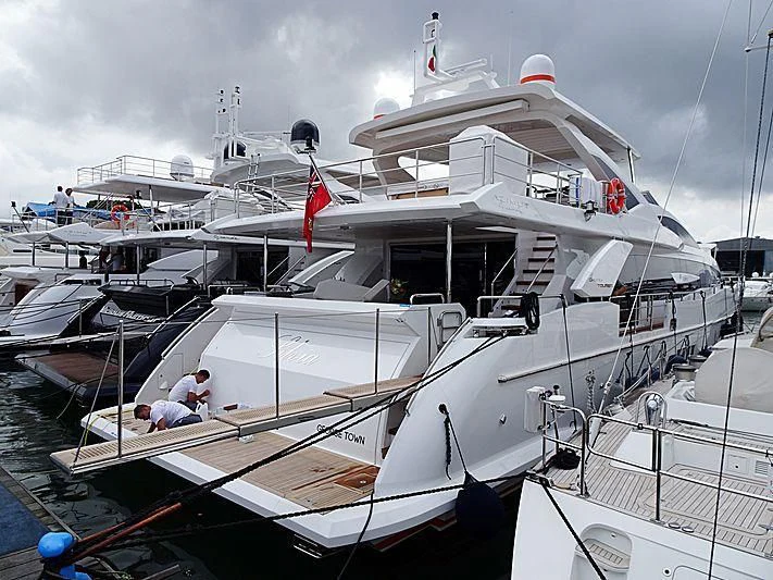 a boat docked with a person sitting on it aboard SILVIA Yacht for Sale