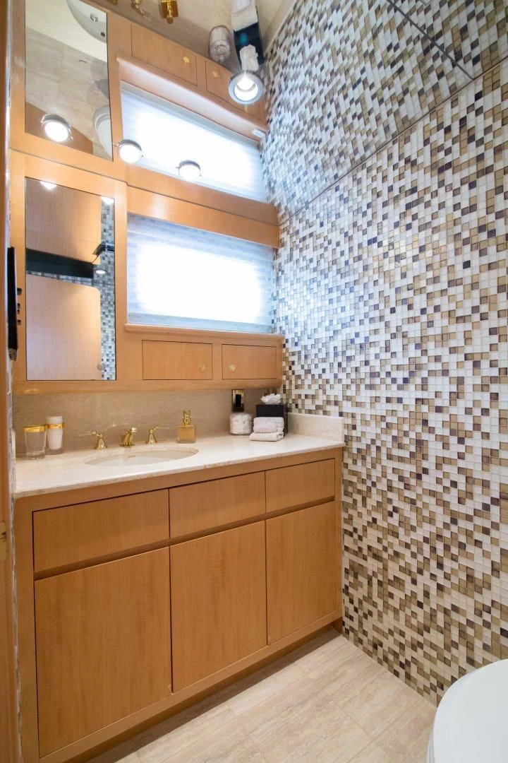 a bathroom with a sink and a shower curtain aboard MALDAU Yacht for Sale