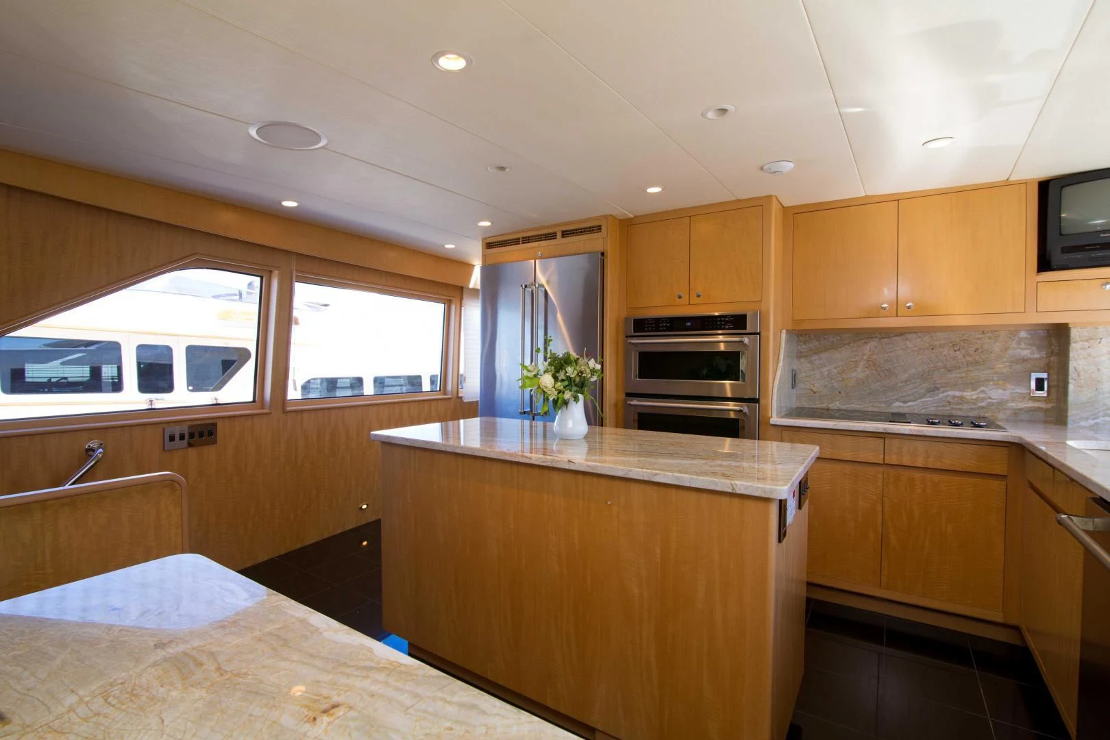 a kitchen with wooden cabinets aboard MALDAU Yacht for Sale