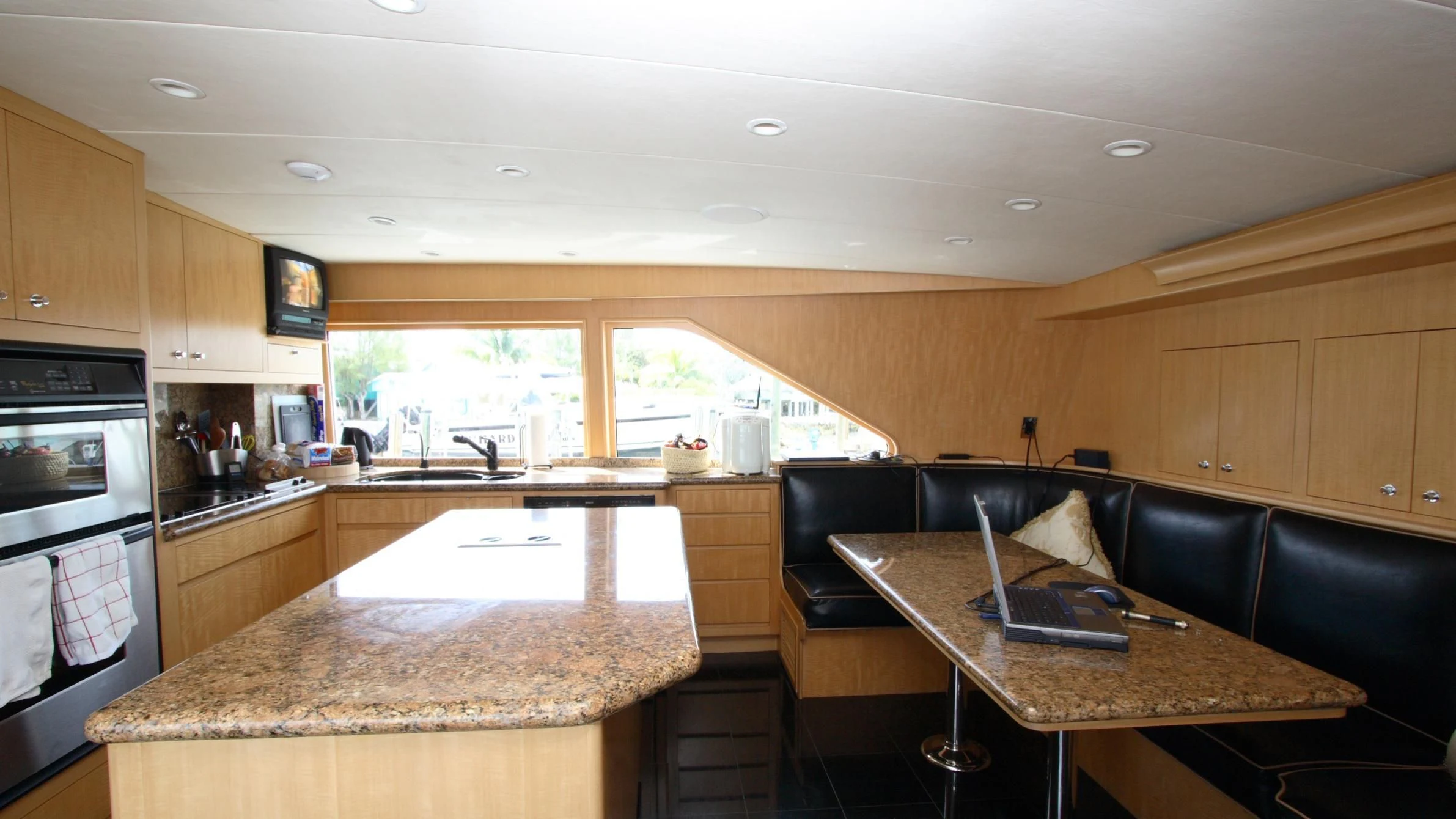 a kitchen with a laptop on the counter aboard MALDAU Yacht for Sale