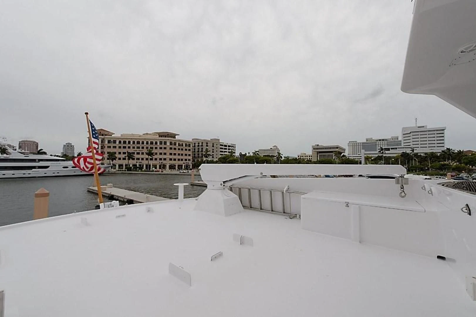 a large snowy area with buildings and flags in the background aboard MALDAU Yacht for Sale