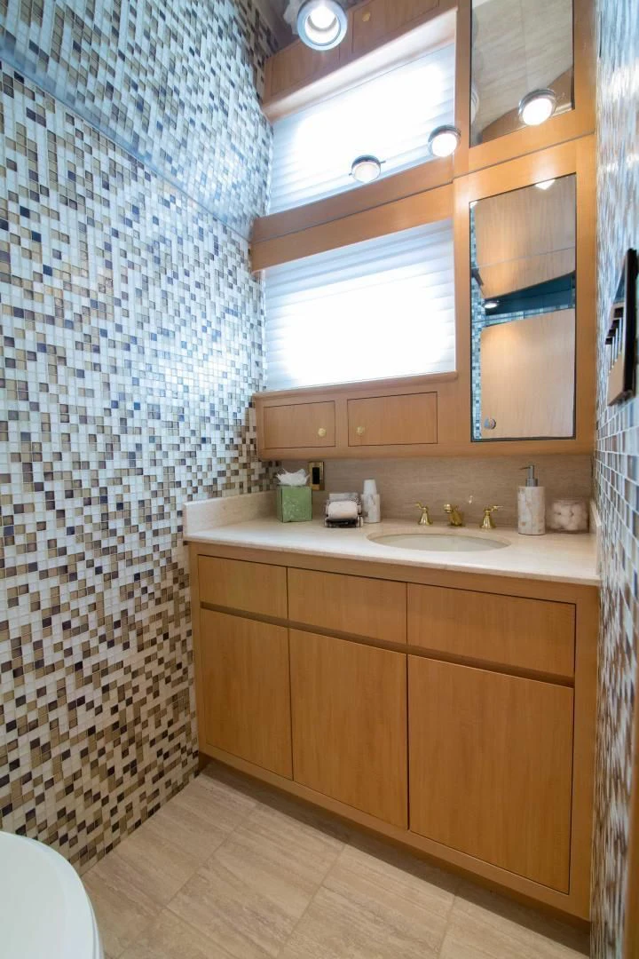 a bathroom with a sink and a shower curtain aboard MALDAU Yacht for Sale
